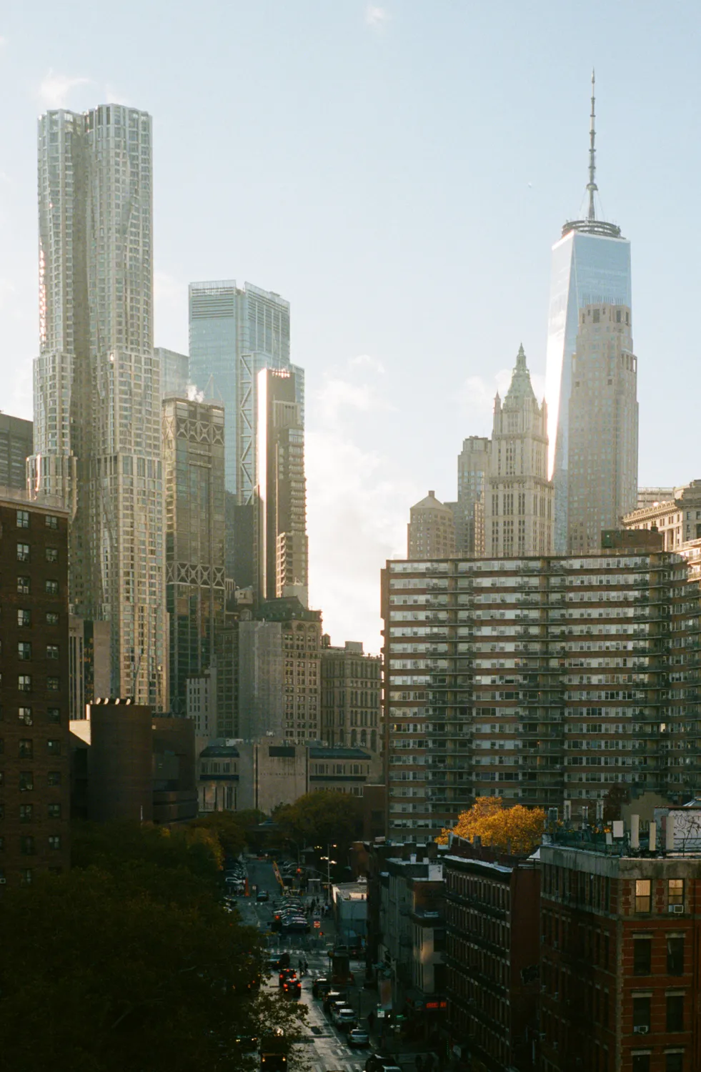 A view of Manhattan skyscrapers including One World Trade Center rising above surrounding city buildings.